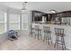 Eat-in kitchen area with dark cabinets, tiled floors and counter seating at 2110 Mcgarity Rd, Mcdonough, GA 30252