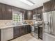 Updated kitchen features stainless steel appliances, dark cabinetry, and modern fixtures at 2110 Mcgarity Rd, Mcdonough, GA 30252
