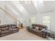 Bright and airy living room with vaulted ceilings, a staircase, and comfortable leather furniture at 2110 Mcgarity Rd, Mcdonough, GA 30252