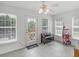 Sunroom with tiled flooring, ceiling fan and lots of windows and natural light at 2110 Mcgarity Rd, Mcdonough, GA 30252