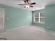 Spacious bedroom with light green walls, carpet flooring, ceiling fan, and a window at 5297 Heron Bay Blvd, Locust Grove, GA 30248