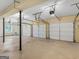 Spacious three-car garage featuring three garage doors and ample space for parking at 5297 Heron Bay Blvd, Locust Grove, GA 30248
