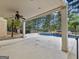 Covered outdoor patio overlooking a pool and lush landscaping, perfect for relaxation and entertaining at 5297 Heron Bay Blvd, Locust Grove, GA 30248