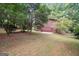 Large backyard with a concrete patio area and privacy from the surrounding trees at 954 Camp Creek Sw Dr, Lilburn, GA 30047