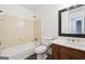 Neutral bathroom featuring a tub/shower combo and classic vanity at 954 Camp Creek Sw Dr, Lilburn, GA 30047