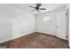 Neutral bedroom featuring carpeted floors, ceiling fan, and a window letting in natural light at 954 Camp Creek Sw Dr, Lilburn, GA 30047