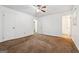 This bedroom has neutral walls, carpet and a ceiling fan at 954 Camp Creek Sw Dr, Lilburn, GA 30047