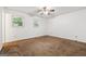 Bright bedroom featuring two windows and a ceiling fan at 954 Camp Creek Sw Dr, Lilburn, GA 30047