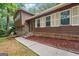 Inviting front entrance with brick accents and a well-kept walkway, enhancing curb appeal at 954 Camp Creek Sw Dr, Lilburn, GA 30047