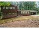 Charming home with a brick and wood exterior, complemented by well-maintained landscaping and a carport at 954 Camp Creek Sw Dr, Lilburn, GA 30047