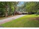 Spacious property with a long driveway and lush greenery, offering a serene and private setting at 954 Camp Creek Sw Dr, Lilburn, GA 30047