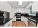 Traditional kitchen with white cabinetry, stainless appliances and dark granite countertops at 954 Camp Creek Sw Dr, Lilburn, GA 30047