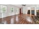 Bright living room features wood floors, large windows, fireplace, and open floor plan at 954 Camp Creek Sw Dr, Lilburn, GA 30047