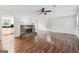 Open-concept living room with wood floors and stone fireplace, creating a cozy and inviting atmosphere at 954 Camp Creek Sw Dr, Lilburn, GA 30047