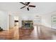 Spacious living room with wood flooring, a fireplace, and plenty of natural light at 954 Camp Creek Sw Dr, Lilburn, GA 30047