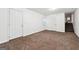 Spacious room with stairs, multiple doors, and neutral carpet creating flexible space at 954 Camp Creek Sw Dr, Lilburn, GA 30047