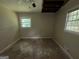 The bedroom in need of repair has two windows overlooking the backyard and a damaged ceiling at 3144 Clemons Rd, Stockbridge, GA 30281