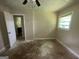 Bedroom featuring neutral walls, a ceiling fan, and a window overlooking the yard at 3144 Clemons Rd, Stockbridge, GA 30281