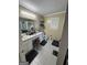 Full bathroom with dual sinks, vanity, and window, featuring tile floors and lots of counter space at 375 Big Game Way, Loganville, GA 30052