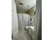 Bathroom featuring marble floors, white vanity, toilet, and patterned shower curtain at 375 Big Game Way, Loganville, GA 30052