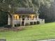 Charming single-story home with covered porch, mature trees, and well-manicured lawn at 375 Big Game Way, Loganville, GA 30052