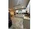 Functional kitchen with white cabinets and modern appliances, leading to a cozy dining space at 375 Big Game Way, Loganville, GA 30052