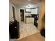 Basement kitchenette featuring white cabinets and black appliances at 375 Big Game Way, Loganville, GA 30052