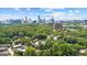 Breathtaking aerial shot of the city skyline, backing onto residences nestled among lush green trees at 32 Ivy Ne Pkwy, Atlanta, GA 30342