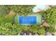 Aerial view of tennis court and community pool bordered by mature trees. A tranquil oasis at 32 Ivy Ne Pkwy, Atlanta, GA 30342