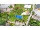 A scenic aerial showcases residences beside swimming and tennis courts, nestled in abundant greenery at 32 Ivy Ne Pkwy, Atlanta, GA 30342