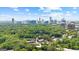 Beautiful aerial view featuring a city skyline behind a community abundant with mature trees at 32 Ivy Ne Pkwy, Atlanta, GA 30342