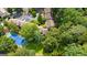 A stunning aerial perspective captures residences beside a tennis court, nestled in abundant greenery at 32 Ivy Ne Pkwy, Atlanta, GA 30342