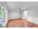 This bright bedroom has hardwood floors, a ceiling fan, and a large window providing natural light at 32 Ivy Ne Pkwy, Atlanta, GA 30342