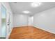 Spacious bedroom featuring beautiful wood floors, neutral walls, and access to the outdoors at 32 Ivy Ne Pkwy, Atlanta, GA 30342