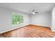 Bright bedroom boasts hardwood floors, a ceiling fan, large window with a picturesque outdoor view at 32 Ivy Ne Pkwy, Atlanta, GA 30342