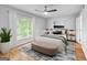 Staged bedroom featuring hardwood floors and a large window at 32 Ivy Ne Pkwy, Atlanta, GA 30342