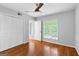 Bedroom with hardwood floors, a ceiling fan, a large window, and closet at 32 Ivy Ne Pkwy, Atlanta, GA 30342