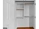 Walk-in closet with wooden shelves and hanging rods at 32 Ivy Ne Pkwy, Atlanta, GA 30342