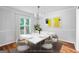 Staged dining room featuring modern table with seating, minimalist wall art, and bright natural light at 32 Ivy Ne Pkwy, Atlanta, GA 30342