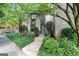Charming townhome entrance with lush landscaping, stone walkway, and a modern glass front door at 32 Ivy Ne Pkwy, Atlanta, GA 30342