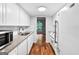 Modern kitchen features white cabinets, granite counters, and view into dining room at 32 Ivy Ne Pkwy, Atlanta, GA 30342