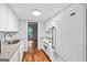 Well-lit kitchen with white cabinets, subway tile backsplash, and view into the dining room at 32 Ivy Ne Pkwy, Atlanta, GA 30342