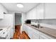 Efficient galley kitchen featuring white cabinets, granite countertops, and modern appliances at 32 Ivy Ne Pkwy, Atlanta, GA 30342