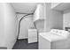Practical laundry area equipped with a washer, dryer, and storage cabinets at 32 Ivy Ne Pkwy, Atlanta, GA 30342