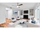Virtually staged living room with hardwood floors, built-in shelving, fireplace and modern furniture at 32 Ivy Ne Pkwy, Atlanta, GA 30342