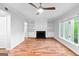 The living room features hardwood floors, a ceiling fan, fireplace with built-in shelving, and natural light at 32 Ivy Ne Pkwy, Atlanta, GA 30342
