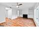 Bright living room features hardwood floors, a ceiling fan, fireplace with built-in shelving, and large windows at 32 Ivy Ne Pkwy, Atlanta, GA 30342