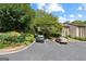 Apartment parking area surrounded by lush landscaping and mature trees at 32 Ivy Ne Pkwy, Atlanta, GA 30342