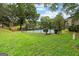 Fenced tennis court set amidst lush landscaping provides active recreation for the community at 32 Ivy Ne Pkwy, Atlanta, GA 30342