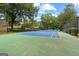 A tennis court surrounded by mature trees offers an active outdoor lifestyle and recreation at 32 Ivy Ne Pkwy, Atlanta, GA 30342